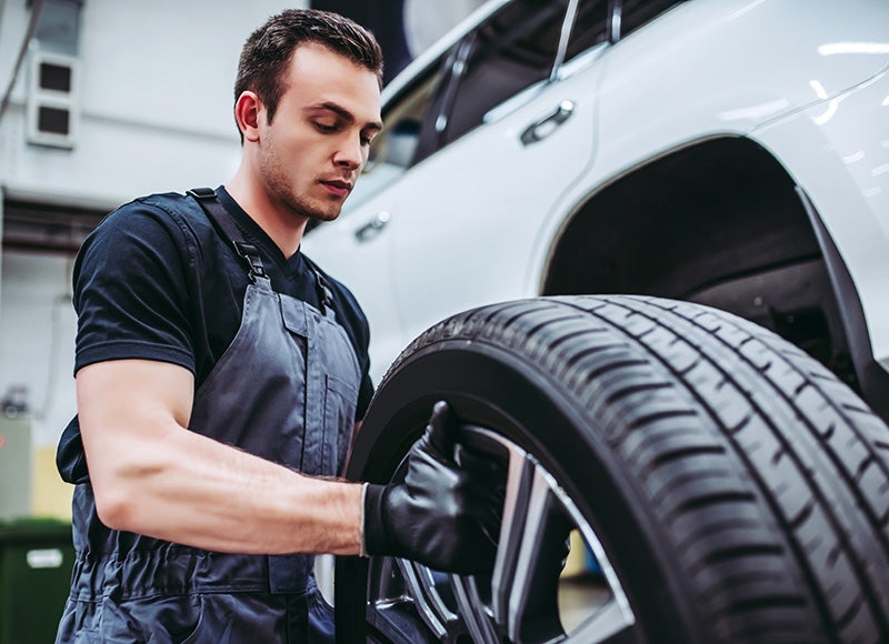 Man rolling a tire