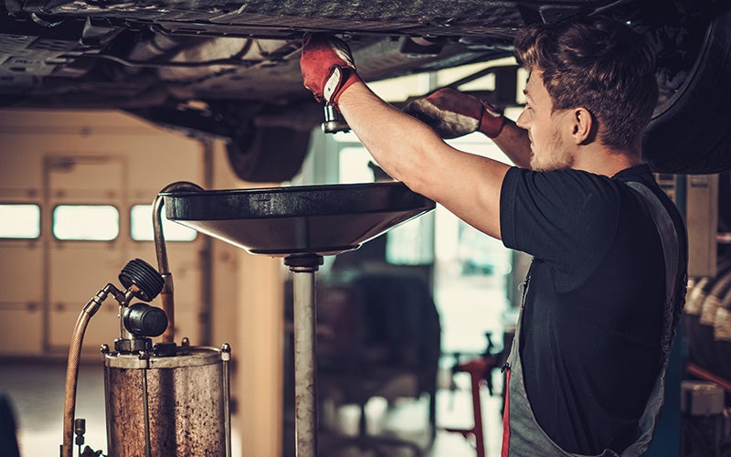 an auto technician works on a Cadillac in Medina, OH